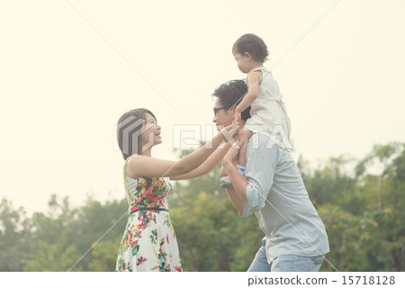 asian family playing and enjoying quality time outdoor 15718128