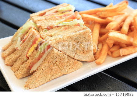 Delicious clubhouse sandwich and french fries 15719082