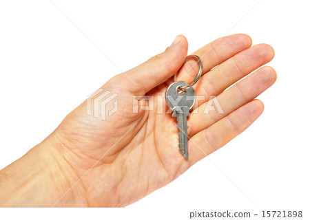 Silver key in a hand isolated on white. Silver key in a hand isolated on white. 15721898