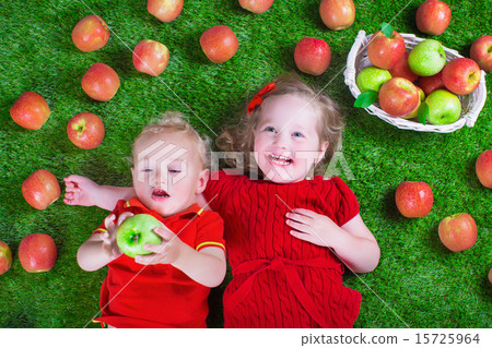 Little childrenl eating apples Little childrenl eating apples 15725964