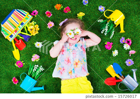 Kids on a lawn with garden tools 15726017