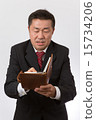 Take a businessman note with a notebook 15734206
