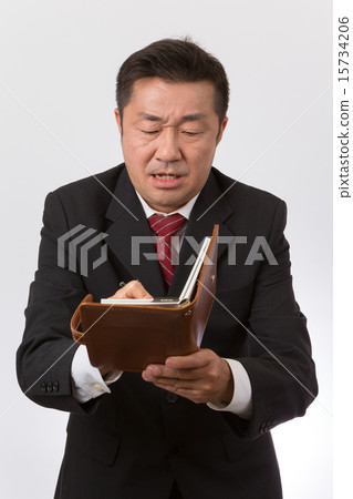 Take a businessman note with a notebook 15734206