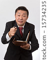 Listen to a businessman with a notebook 15734235