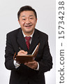 Listen to a businessman with a notebook 15734238