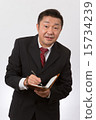 Listen to a businessman with a notebook 15734239