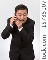 A businessman who apologizes over the mobile phone 15735107