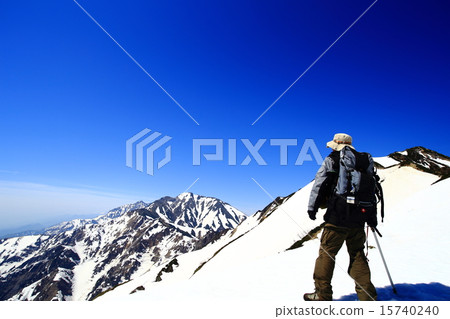 Climber climbing a snowy mountain Climber climbing a snowy mountain 15740240