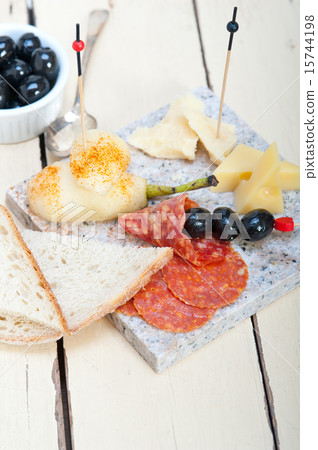 mix cold cut on a stone with fresh pears 15744198