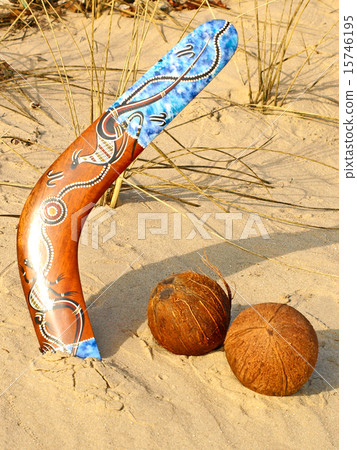 Boomerang and coconuts on a sand. 15746195