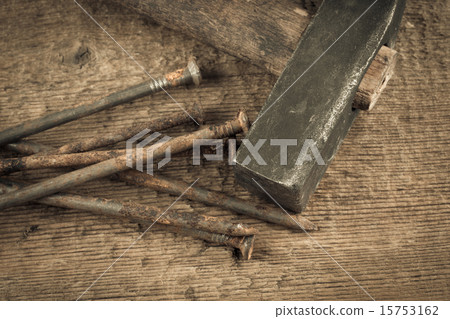 Vintage hammer with nails on wood background Vintage hammer with nails on wood background 15753162