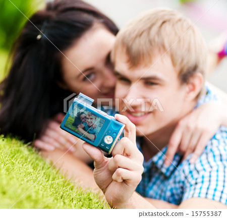 Happy teenage couple taking picture 15755387