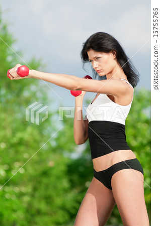 Woman doing exercise with dumbbell Woman doing exercise with dumbbell 15755765