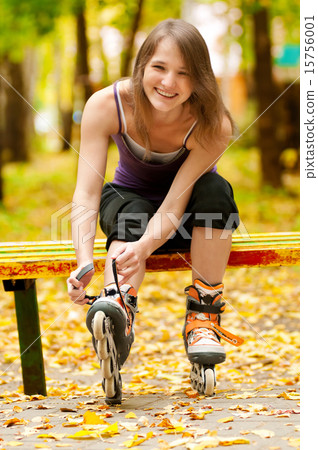 Woman on roller skates in the park Woman on roller skates in the park 15756001