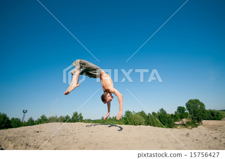 Excited young man jumping in air Excited young man jumping in air 15756427