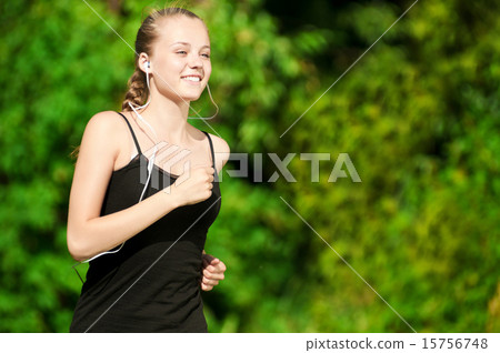 Young woman running in green park Young woman running in green park 15756748