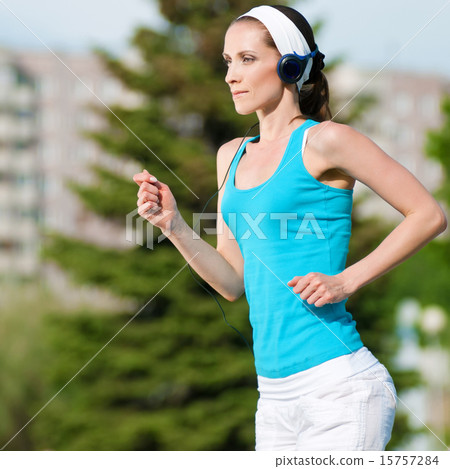 Beautiful woman running in green park 15757284