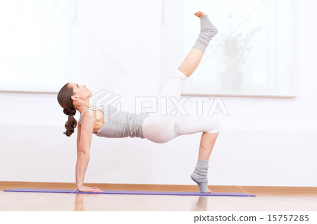 Woman doing stretching yoga exercise at sport gym 15757285