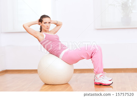 Woman doing stretching exercise on ball Woman doing stretching exercise on ball 15757520