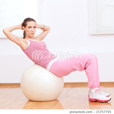 Woman doing stretching exercise on ball Woman doing stretching exercise on ball 15757705