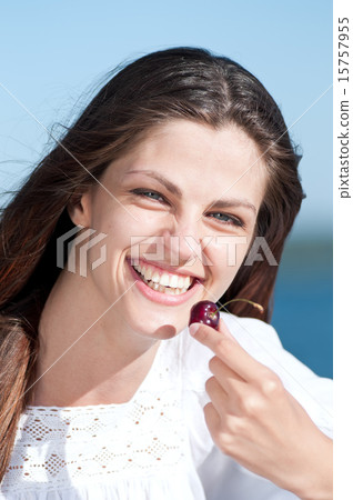Woman on beach eating fruits Woman on beach eating fruits 15757955