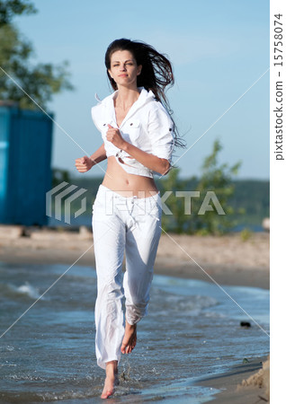 Sporty woman running on water Sporty woman running on water 15758074