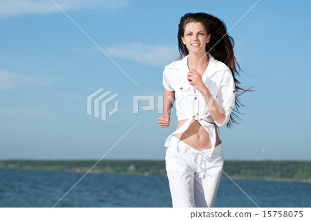 Sporty woman running in sea coast Sporty woman running in sea coast 15758075