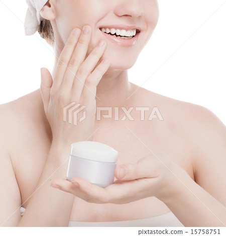 Woman applying moisturizer cream on face 15758751