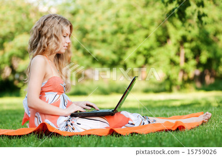 Young woman with laptop at park Young woman with laptop at park 15759026
