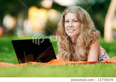 Young woman with laptop at park 15759070