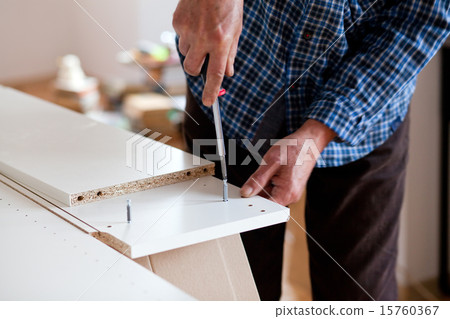 Man Assembling Flat Pack Furniture 15760367