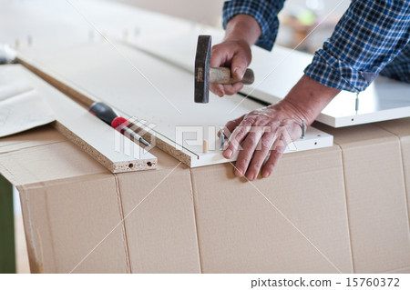 Man Assembling Flat Pack Furniture 15760372