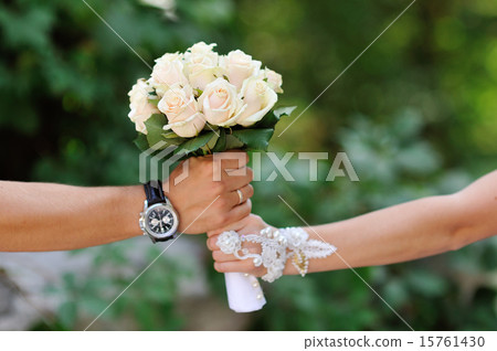 groom gives the bride a bouquet of roses 15761430