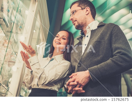 Stock Photo: Man with assistant help choosing jewellery