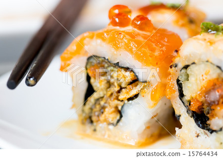 Sushi roll with black chopsticks 15764434