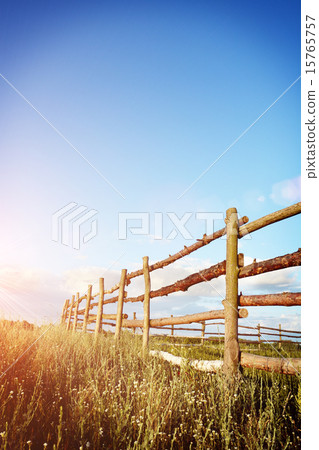Fence in the green field under blue cloud sky Fence in the green field under blue cloud sky 15765757