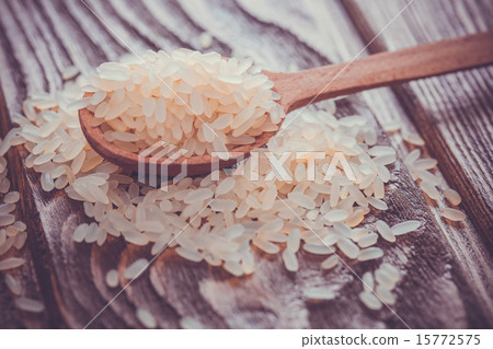 white rice in spoon on wooden background white rice in spoon on wooden background 15772575