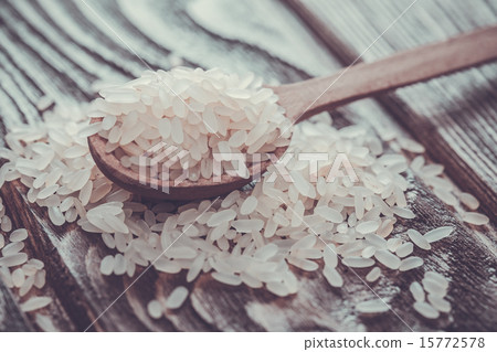 white rice in spoon on wooden background white rice in spoon on wooden background 15772578