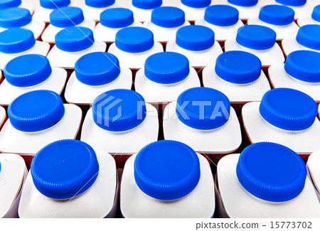 dairy products bottles stand in rows, bright cover 15773702