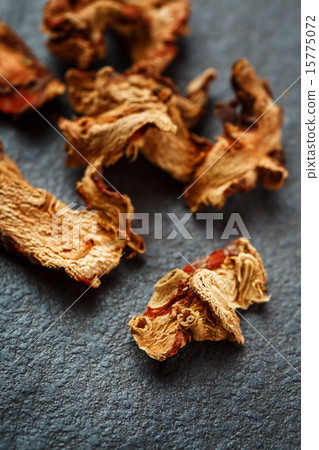 Dried Galangal Root in Close Up on Dark Stone Dried Galangal Root in Close Up on Dark Stone 15775072