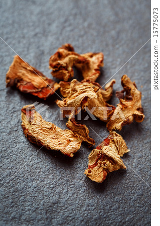 Dried Galangal Root in Close Up on Dark Stone 15775073
