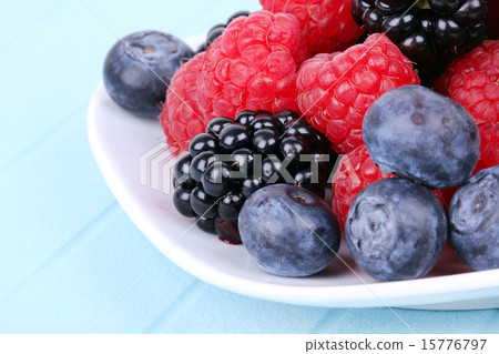 Different berries on plate 15776797
