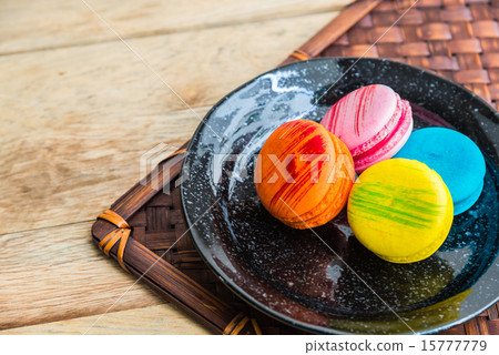 Colorful macaron in black dish on wooden floor 6 Colorful macaron in black dish on wooden floor 6 15777779