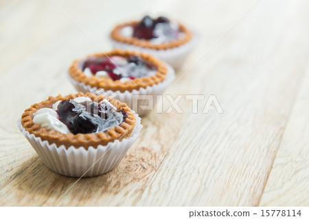Three Blue berry tart on wooden floor 2 15778114