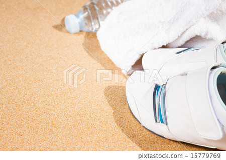 white sneakers in sand  15779769