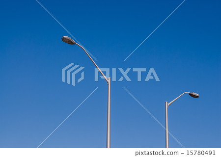 Two tall street lights on sky Two tall street lights on sky 15780491