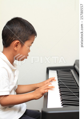 Infant playing the piano (5 years old child) 15780557