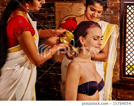 Woman having ayurveda spa treatment. 15784054