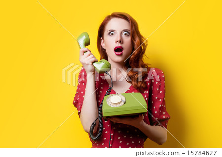girl in red dress with green dial phone 15784627