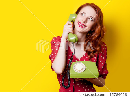 girl in red dress with green dial phone 15784628